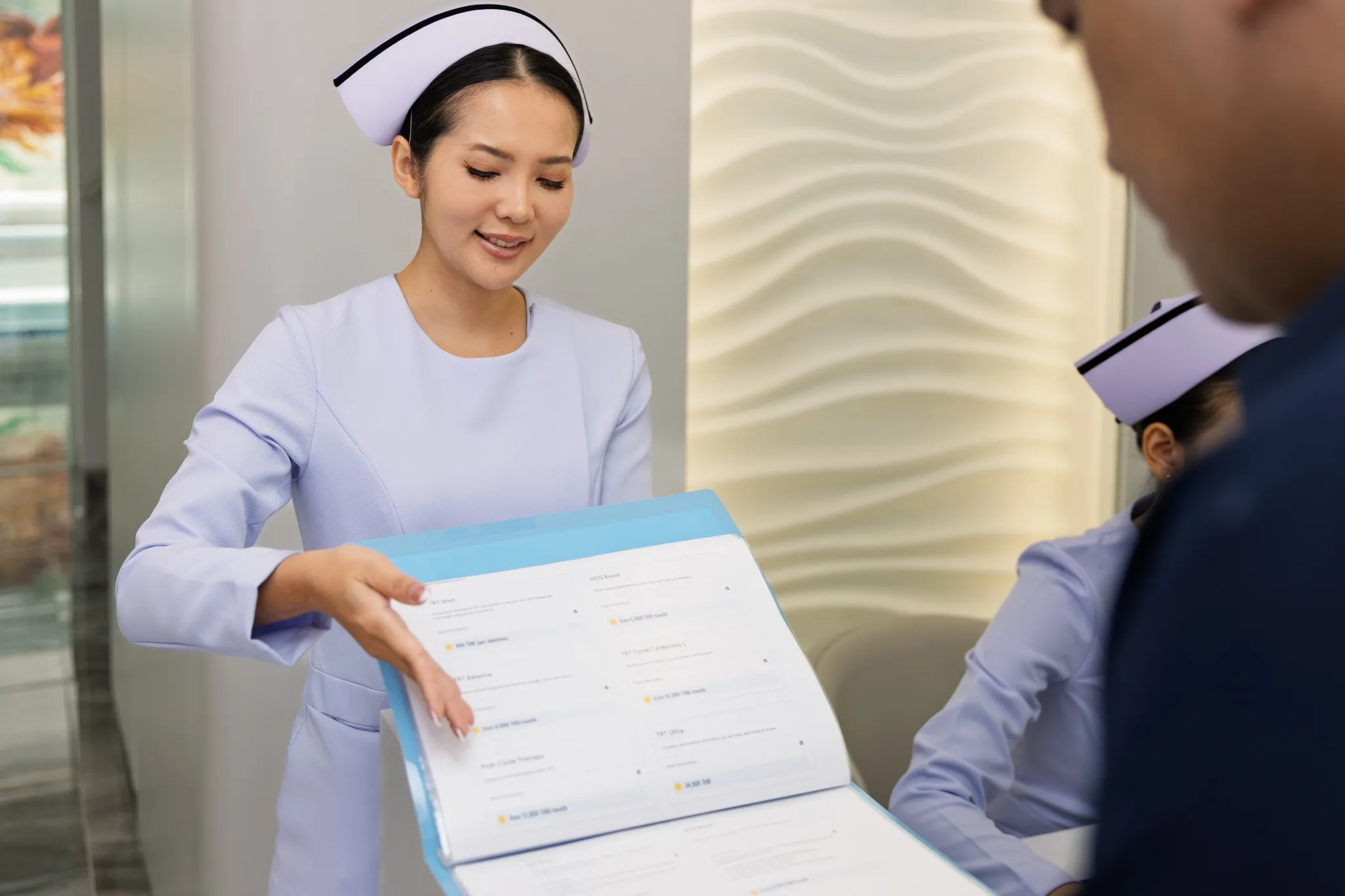 Nurse presenting IV treatment menu to patient